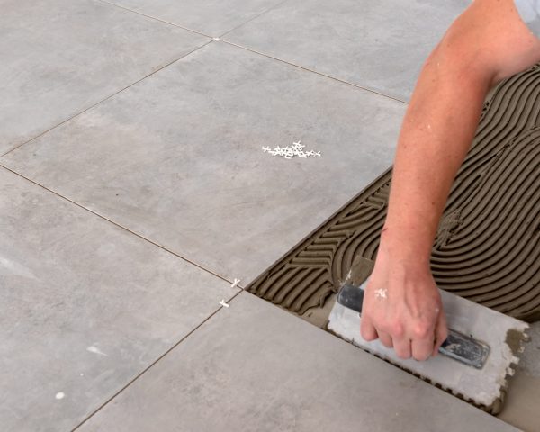 Floor tiles installation. Home improvement, renovation, ceramic tile floor adhesive,